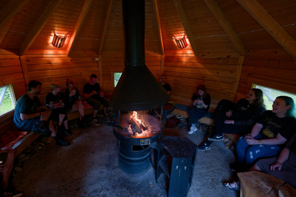 Students sitting in wooden hut