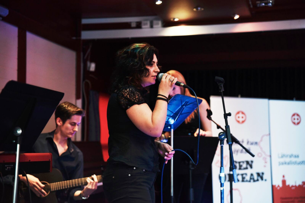 She is giving performance on the stage