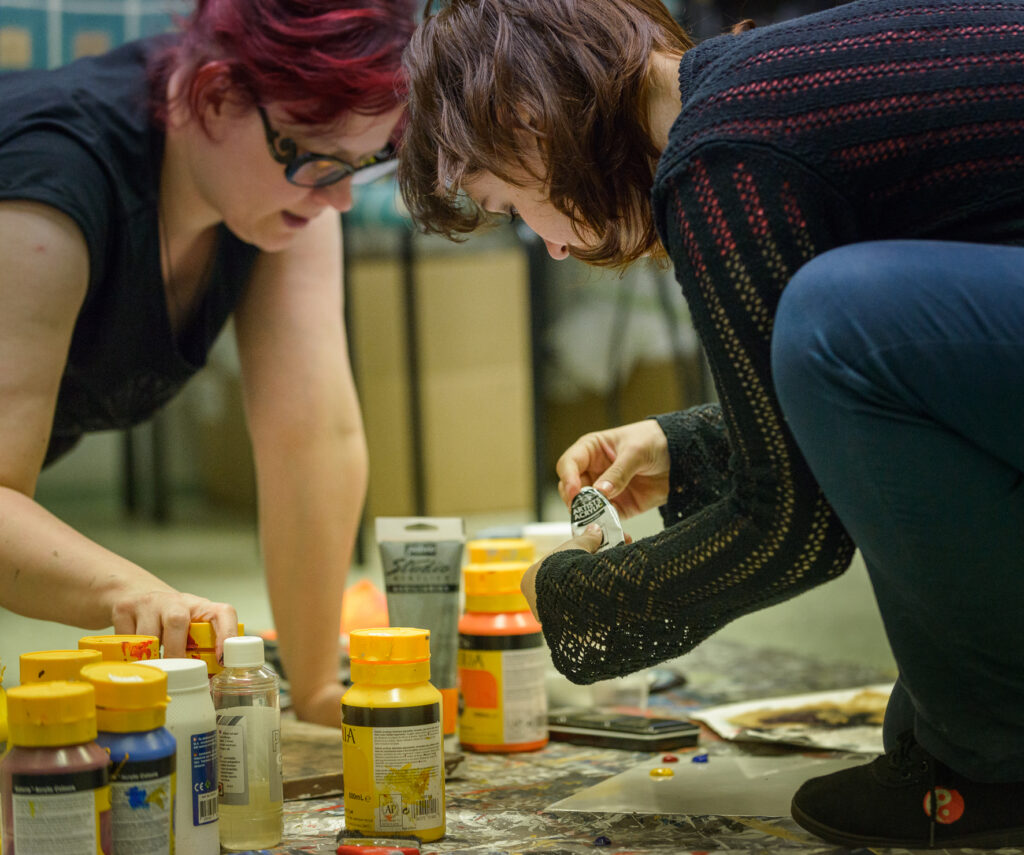 Two womens are doing something creative