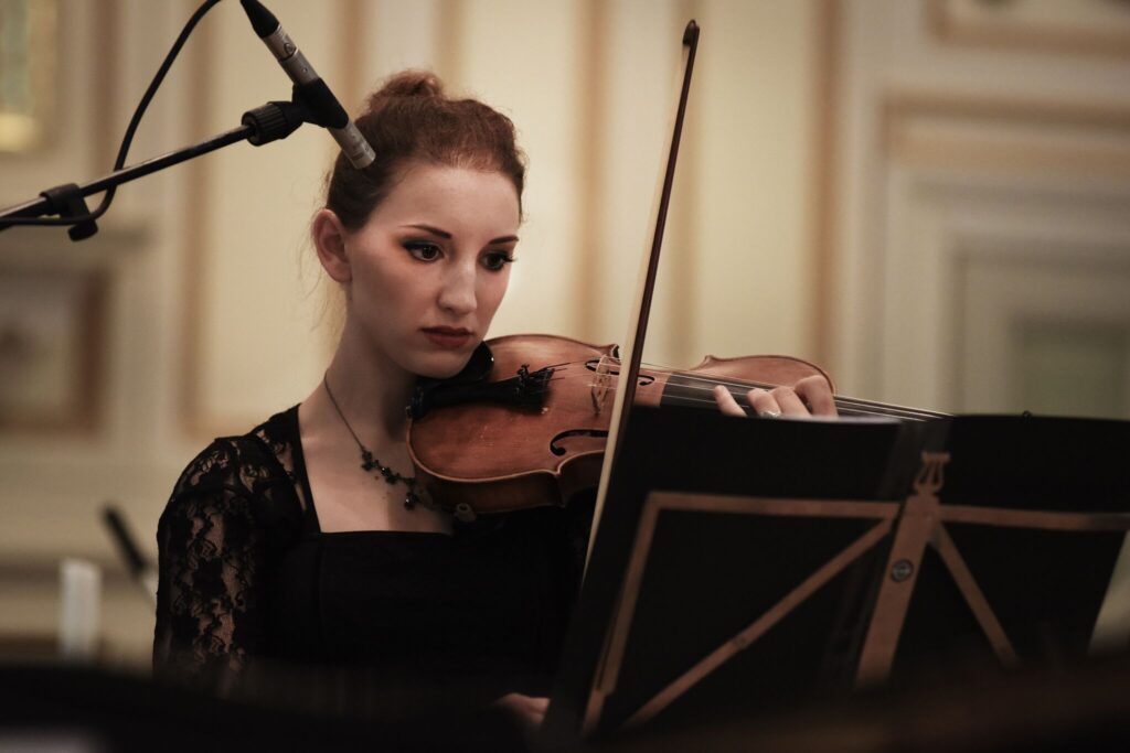 She is playing violin